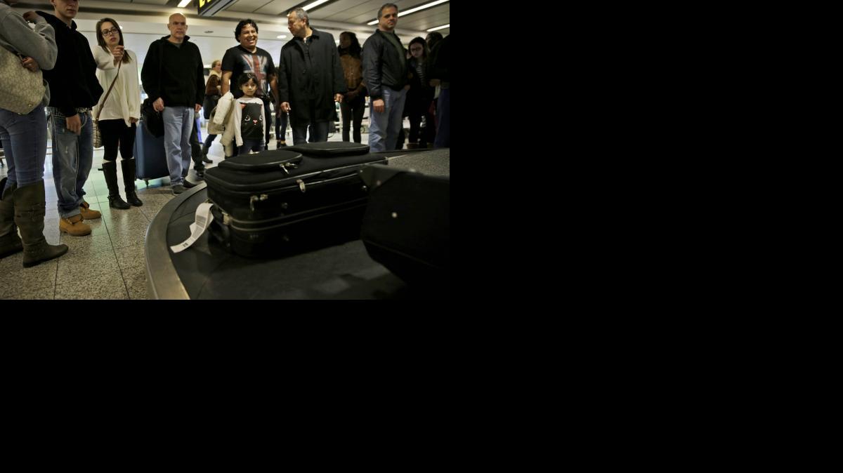 
Travelers wait to claim their baggage at LaGuardia Airport in New York on Nov. 25. An annual report being released Monday states that government data shows more flights are late, more bags are getting lost, and customers are lodging more complaints about U.S. airlines. 
