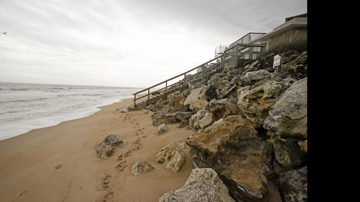 
In this Wednesday, Feb. 4, 2015 photo, a home surrounded by a rock barricade to protect the home from beach erosion is seen on Vilano Beach in St. Augustine, Fla. Homes built on strands of white sand in Vilano Beach now teeter precariously as high tidewaters cover their front steps. 
