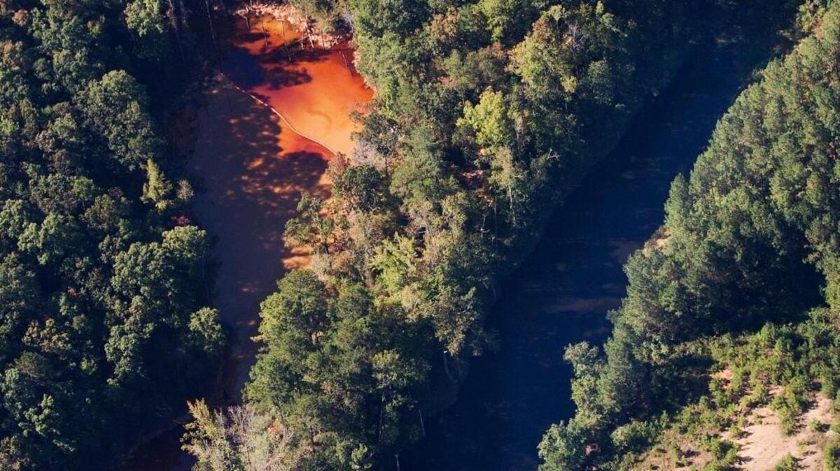 This aerial photo shows a pair of water retention ponds at the site of a pipeline leak, Tuesday, Sept. 20, 2016, near Helena, Ala. The retention pond on the left is where the gasoline has been contained. A main gas line is expected to restart Wednesday with a temporary bypass after a leak and spill in Alabama led to surging fuel prices and some gas shortages across the South, a Colonial Pipeline official said Tuesday.