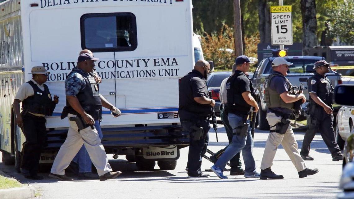 
Law enforcement officers walk across the Delta State University campus on Monday, Sept. 14, 2015, in Cleveland, Miss., after a professor was killed in his office.
