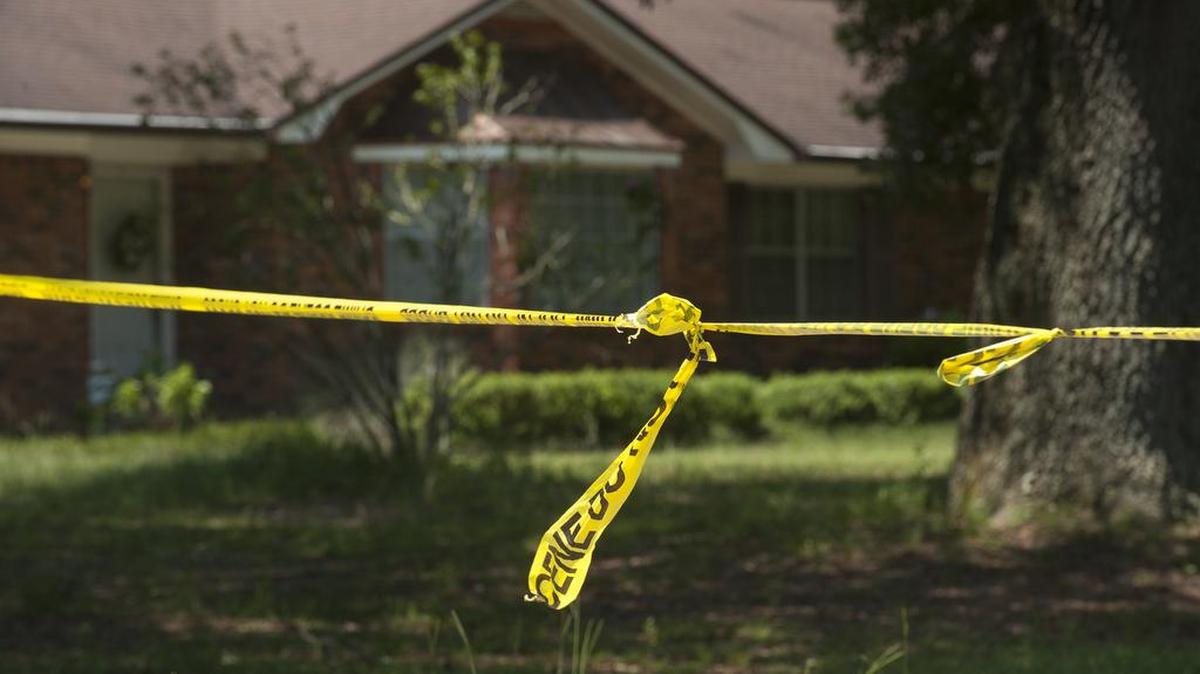 
In this Monday, Aug. 3, 2015 photo, investigative tape is seen near a home in Pensacola, Fla. A triple homicide in Florida is being investigated as a possible ritualistic killing connected to the recent blue moon, Escambia County Sheriff David Morgan said Tuesday, Aug. 4. 
