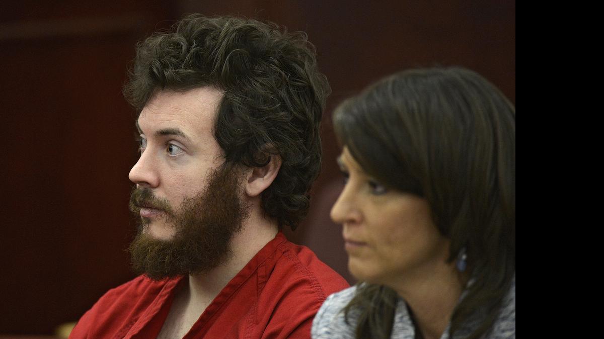 
James Holmes, left, and defense attorney Tamara Brady appear in district court in Centennial, Colo., for his arraignment. Prosecutors are methodically building a case that Holmes knew right from wrong when he planned and carried out the deadly Colorado theater shooting, hoping to convince jurors that he should be convicted and executed and not sent to a mental hospital. 
