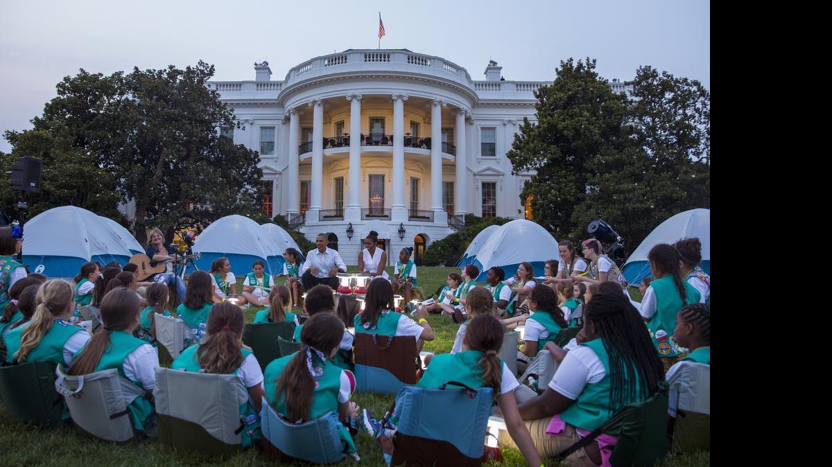 
President Barack Obama and first lady Michelle Obama talk with Girl Scouts during a Lets Move! event on the South Lawn of the White House, on Tuesday.
