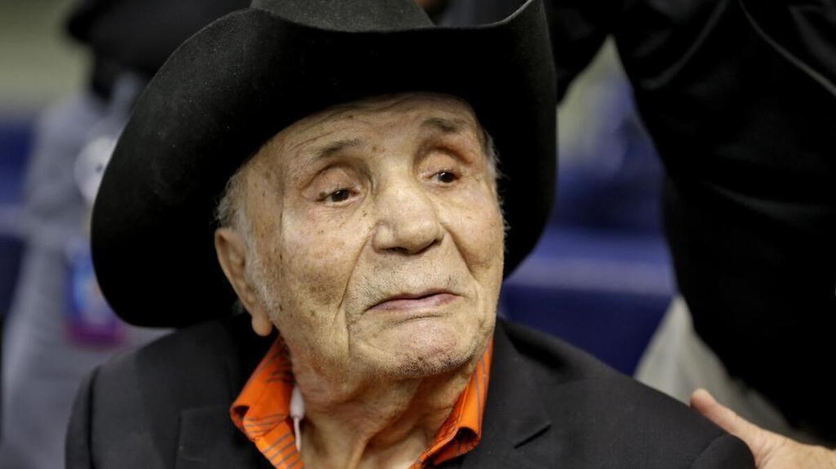 Former middleweight boxing champion Jake LaMotta watches batting practice before a baseball game between the Tampa Bay Rays and the New York Yankees Tuesday, Sept. 15, 2015, in St. Petersburg, Fla. LaMotta died Tuesday at the age of 95.