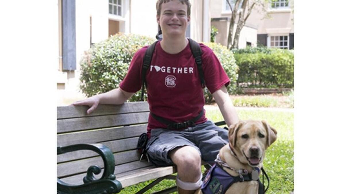 University of South Carolina senior Jory Fleming and his service dog, Daisy.