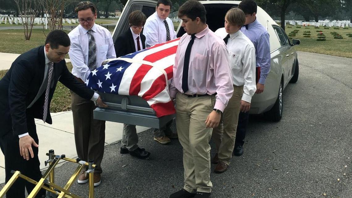 Long Beach students JT Tripp, Bailey Griffin, Joseph Ebberman, Jake Strong, Kenny McNutt and James Kneiss serve as pallbearers Tuesday for a Navy veteran who had no family.