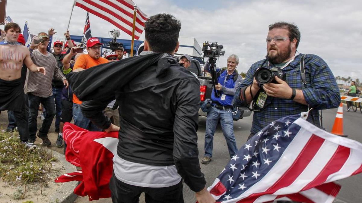 A scuffule breaks out during a Make America Great Again March on Saturday, March 25, 2017, in Huntington Beach, Calif.