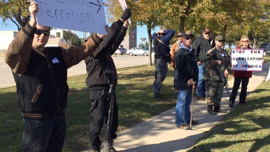 Armed demonstrators hold a protest outside the Islamic Center of Irving in the Dallas suburb of Irving, Texas. The movement has rallied against gun control efforts, patrolled the border with Mexico and recently begun confronting Muslim Americans.