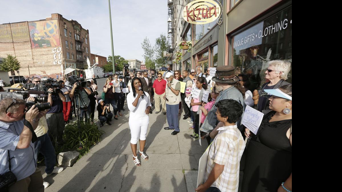 
Kitara Johnson, center, speaks during a demonstration Monday in Spokane, Wash. Rachel Dolezal resigned as president of the NAACP's Spokane chapter Monday just days after her parents said she is a white woman posing as black.
