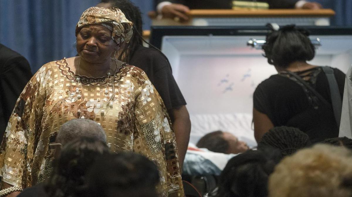 
Audrey Dubose, left, mother of Samuel Dubose, stands near his casket during funeral services at the Church of the Living God in the Avondale neighborhood of Cincinnati, Tuesday, July 28, 2015. Dubose was fatally shot by a University of Cincinnati police officer who stopped him for a missing license plate. 
