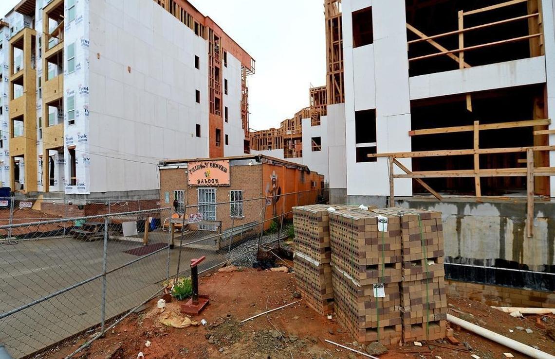 The Thirsty Beaver at 1225 Central Ave. is dwarfed by nearby apartments under construction.