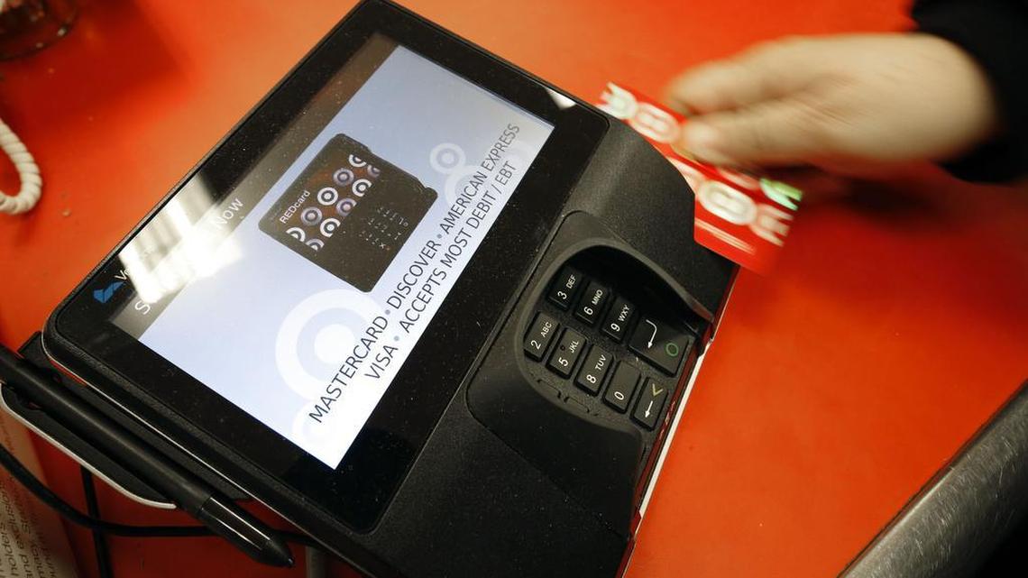 A shopper pays for her purchases at a Target store. 