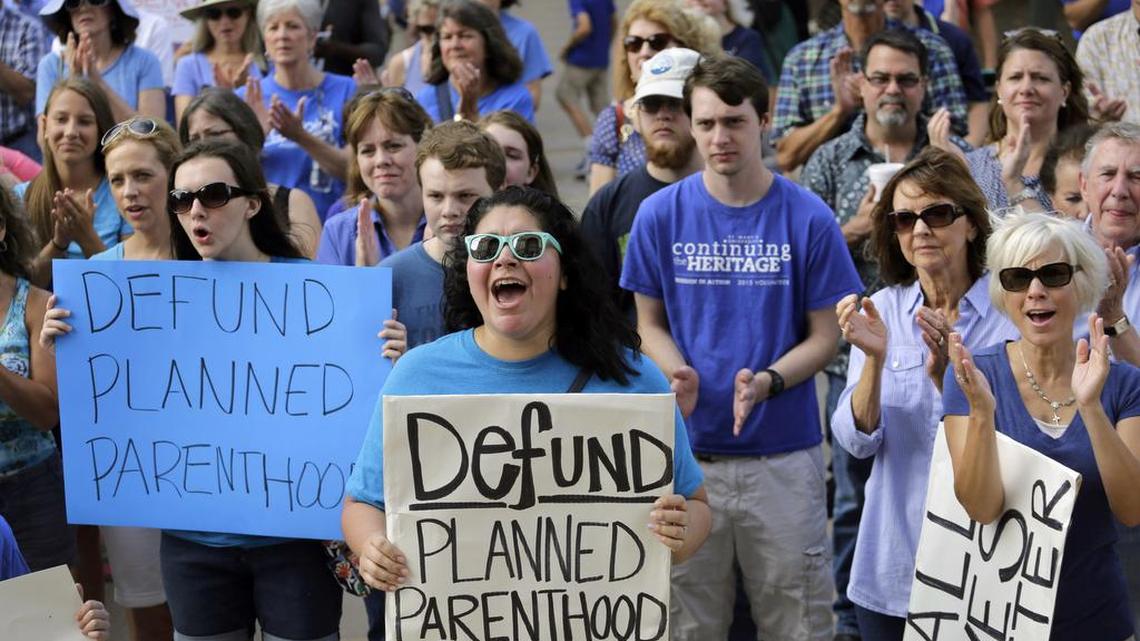 
In this July 28, 2015, photo, Erica Canaut, center, cheers as she and other anti-abortion activists rally on the steps of the Texas Capitol in Austin, Texas, to condemn the use in medical research of tissue samples obtained from aborted fetuses. Texas announced Monday, Oct. 19, 2015, that it was cutting off Medicaid funding to Planned Parenthood clinics following undercover videos of officials discussing fetal tissue, potentially triggering a legal fight like the one unfolding in neighboring Louisiana. 
