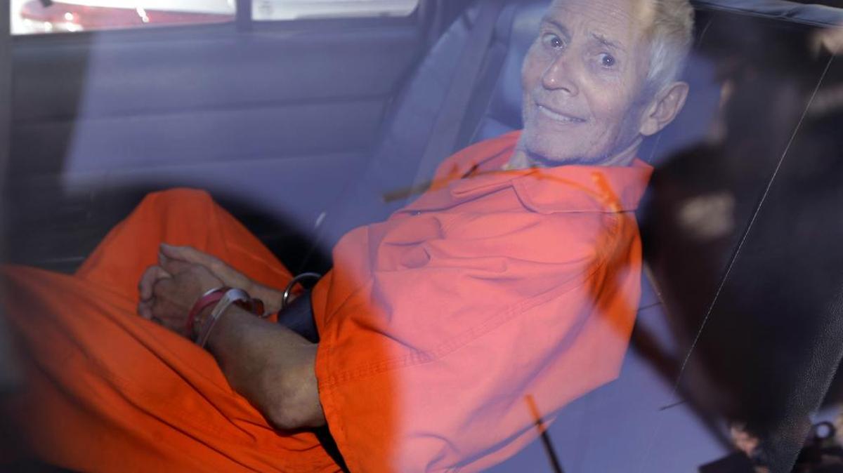 In this Tuesday, March 17, 2015 file photo, Robert Durst is transported from Orleans Parish Criminal District Court to the Orleans Parish Prison after his arraignment on murder charges in New Orleans. U.S. District Judge Kurt Engelhardt has scheduled Durst’s re-arraignment for Wednesday, Feb. 3, 2016, on a charge of illegally carrying a .38-caliber revolver after a felony conviction.