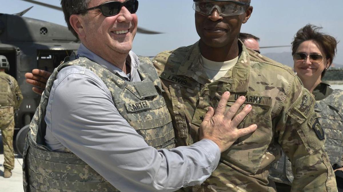 In this photo provided by the Department of Defense, then-U.S. Army Brig. Gen. Ron Lewis, right, greets then-Deputy Secretary of Defense Ash Carter, left, in Jalalabad, Afghanistan, on May 13, 2013.
