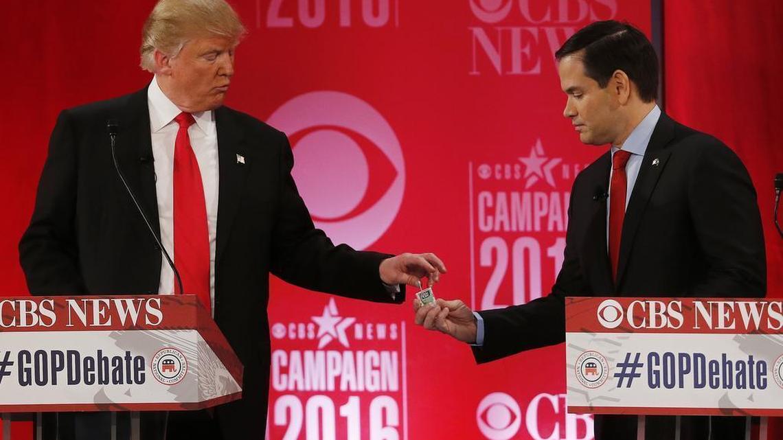 Republican presidential candidate, Sen. Marco Rubio, R-Fla., right, hands Republican presidential candidate, businessman Donald Trump a tic tac container at a break during the CBS News Republican presidential debate at the Peace Center, Feb. 13, 2016, in Greenville, S.C.