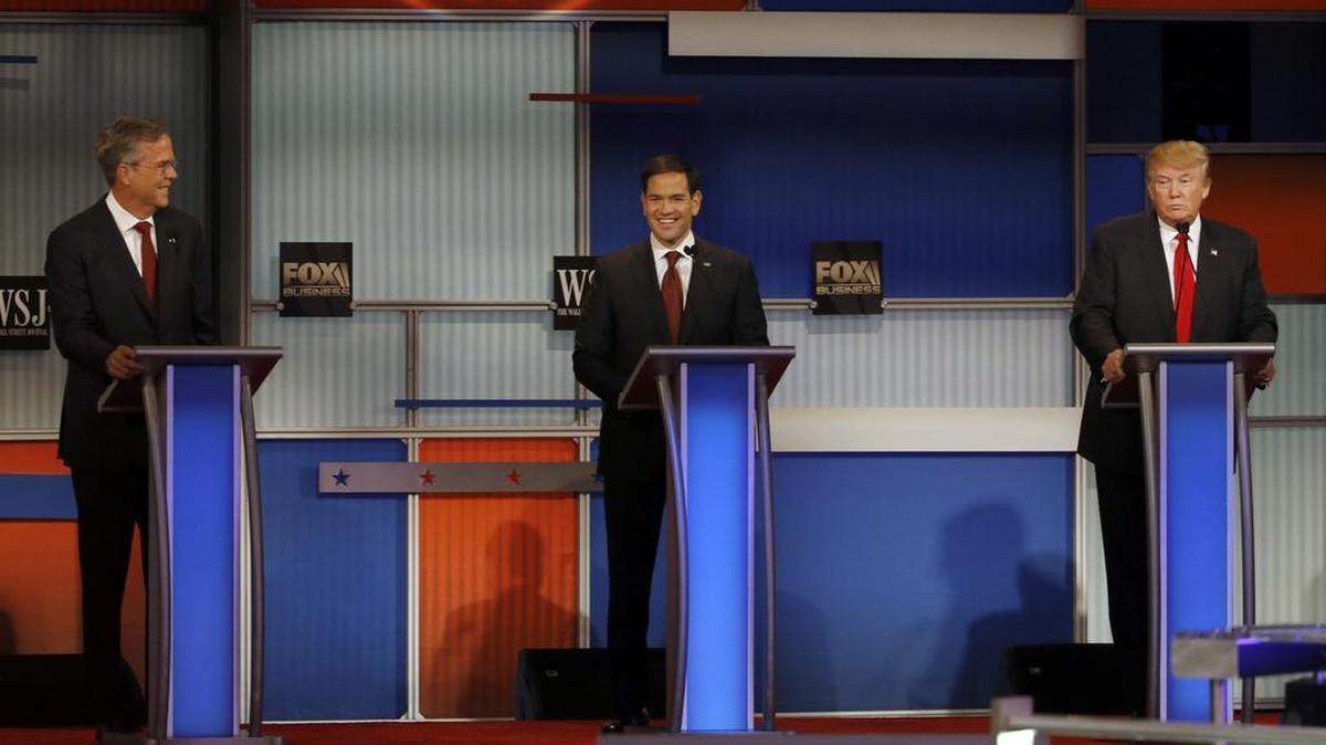 Jeb Bush, left, Marco Rubio and Donald Trump react during Republican presidential debate Tuesday.