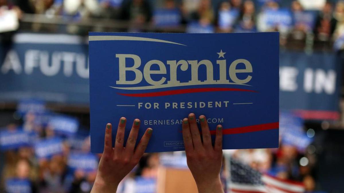 A fan holds up as sign as Democratic presidential candidate, Sen. Bernie Sanders, I-Vt., speaks during a campaign stop Monday in Manchester, N.H.