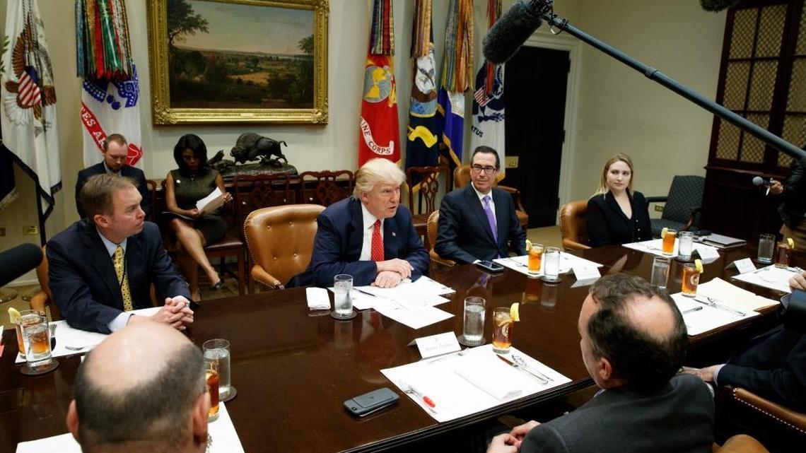 President Donald Trump, flanked by Budget Director Mick Mulvaney, left, and Treasury Secretary Steve Mnuchin during a meeting on the federal budget Wednesday.