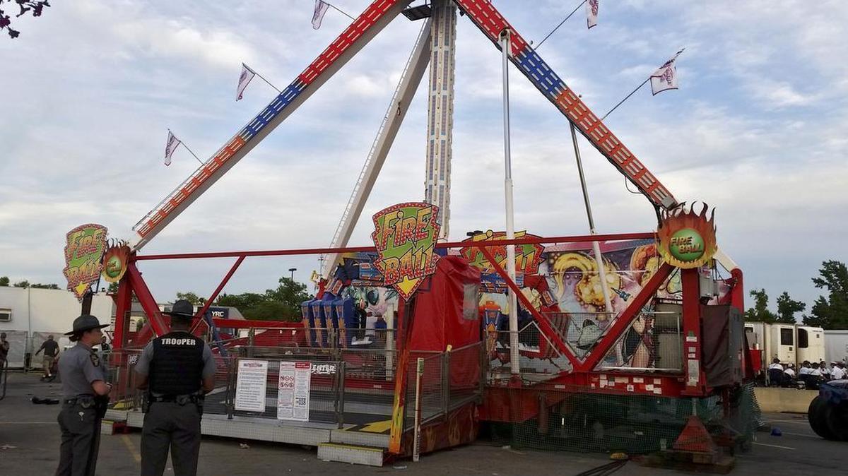 Authorities stand near the Fire Ball amusement ride after the ride malfunctioned injuring several at the Ohio State Fair, Wednesday, July 26, 2017, in Columbus, Ohio. Some of the victims were thrown from the ride when it malfunctioned Wednesday night, said Columbus Battalion Chief Steve Martin.