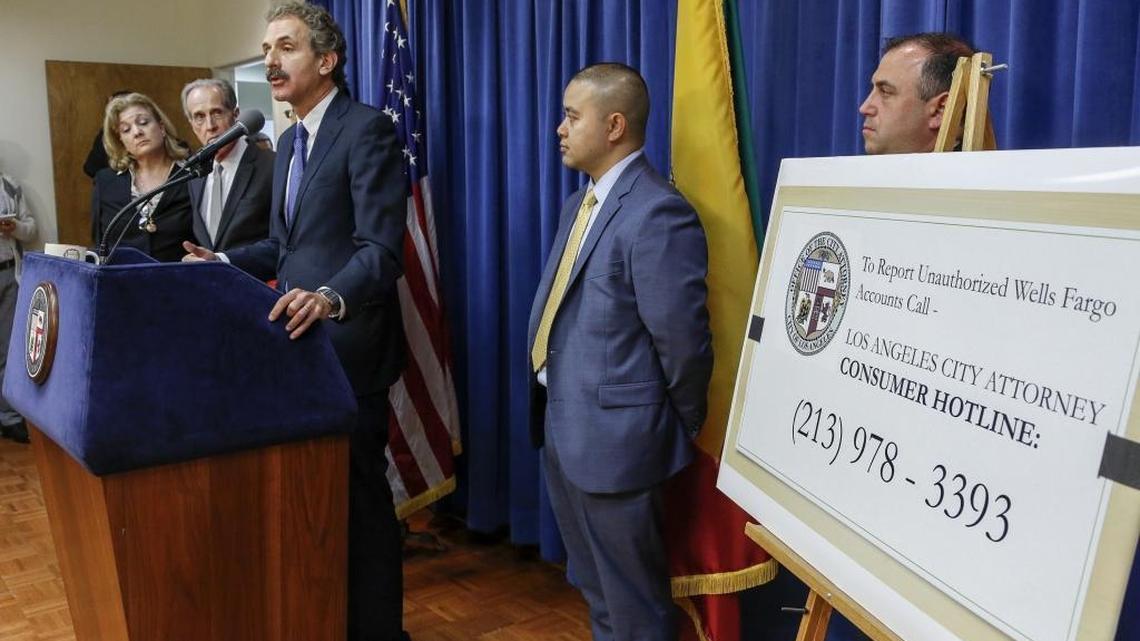 Los Angeles City Attorney Mike Feuer, third from left at podium, with members of his office legal team, comments on a lawsuit filed against Wells Fargo Bank, during a news conference in May 2015. On Thursday, Feuer and federal bank regulators announced $185 million in fines against Wells Fargo in connection with employees secretly opening customer accounts.