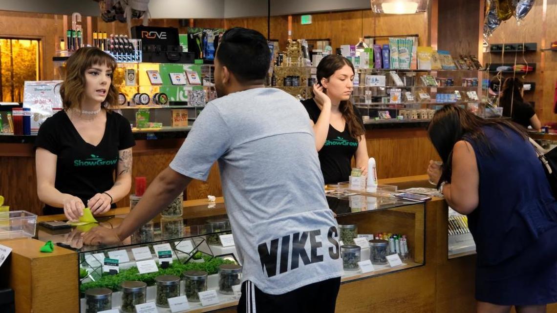 Customers at ShowGrow, a marijuana dispensary in downtown Los Angeles, shop for weed on April 20, 2017. Most cannabis businesses do all of their transactions in cash since banks shun enterprises that are illegal under federal law. The cannabis industry and many states are lobbying Congress to change U.S. law, so that state-approved marijuana businesses can use banks and become less vulnerable to robbers.
