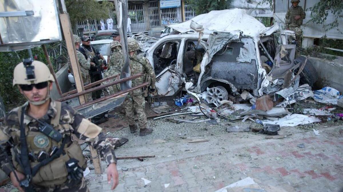 
Afghan security forces and British soldiers inspect the site of a suicide attack in the heart of Kabul, Afghanistan, on Saturday, Aug. 22, 2015. The suicide car bomber attacked a NATO convoy traveling through a crowded neighborhood in Afghanistan's capital Saturday, killing at least 10 people, including three NATO contractors, authorities said.
