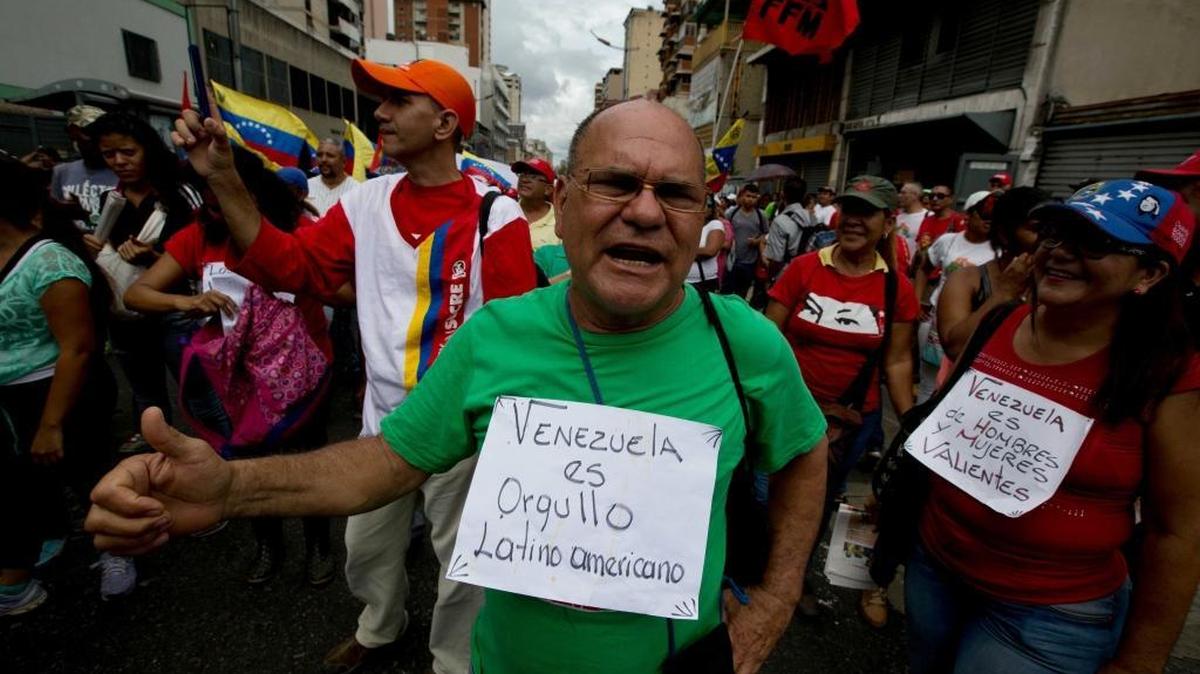 A supporter of Venezuela's President Nicolás Maduro wears a sign that reads in Spanish "Venezuela is Latin American pride" and shouts slogans in support of Maduro at a rally Wednesday, June 1, 2016, in Caracas, Venezuela.
