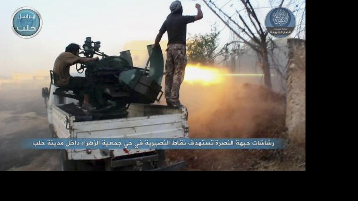 
In this image posted on the Twitter page of Syria's al-Qaida-linked Nusra Front on Tuesday, July 7, 2015, fighters from the Nusra Front fire their weapons at Syrian government forces at the western Zahra neighborhood in Aleppo city, Syria. 
