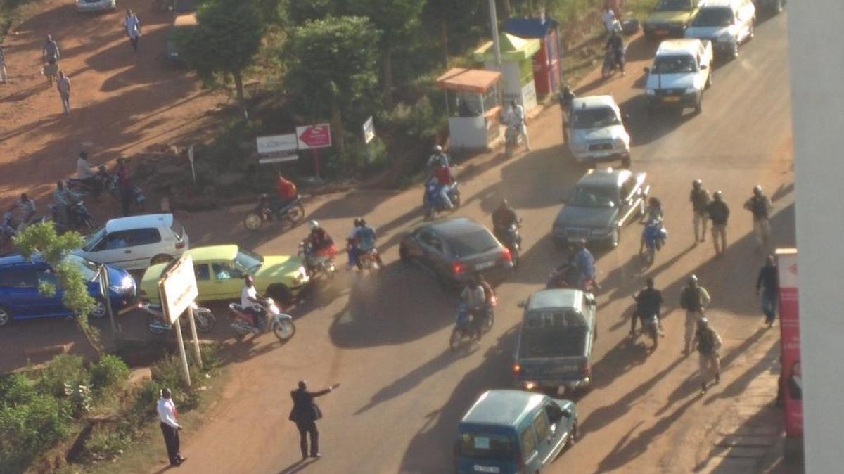 In this image made available by Malikahere.com security personnel, right, attend close to the scene of an attack on a hotel in Bamako, Mali Friday Nov. 20, 2015. Men shouting "God is great" and armed with guns and throwing grenades stormed into the Radisson Blu Hotel in Mali's capital Friday morning.