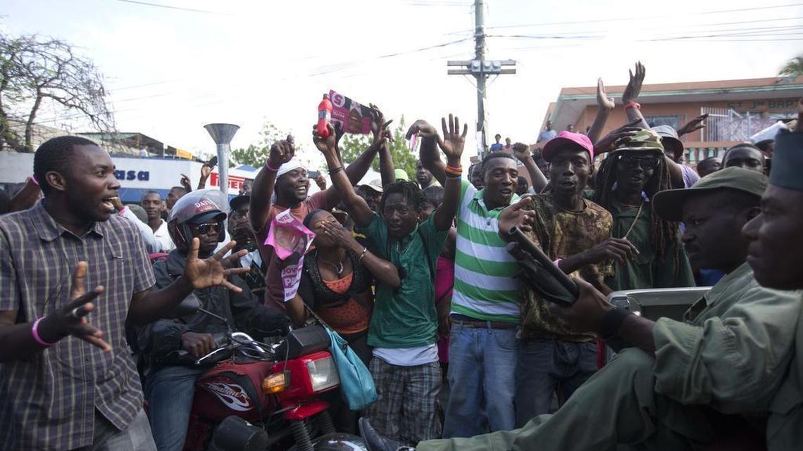Government supporters cheer as armed members of Haiti’s disbanded army pass by during their protest to demand presidential elections in Port-au-Prince on Friday, Feb. 5, 2016. Current President Michel Martelly is leaving office Sunday as a runoff vote to choose his successor has been indefinitely postponed. At a different location, the ex-soldiers clashed with anti-government protesters, where a former soldier was beaten to death. Haiti’s military was abolished in 1995 because of its history of toppling governments and crushing dissent.