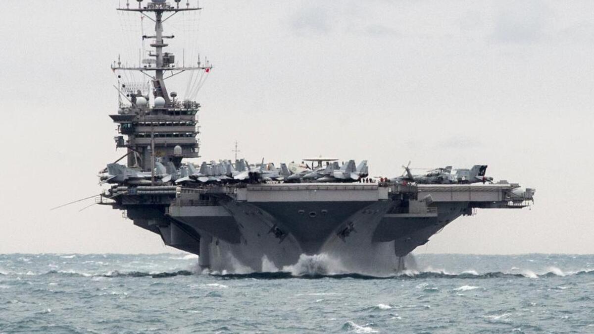In this Saturday, Dec. 26, 2015, photo released by the U.S. Navy, the aircraft carrier USS Harry S. Truman transits the Strait of Hormuz. Iranian naval vessels conducted rocket tests last week near the USS Harry S. Truman aircraft carrier, the USS Bulkeley destroyer and a French frigate, the FS Provence, and commercial traffic passing through the Strait of Hormuz, the American military said Wednesday, Dec. 30, 2015.