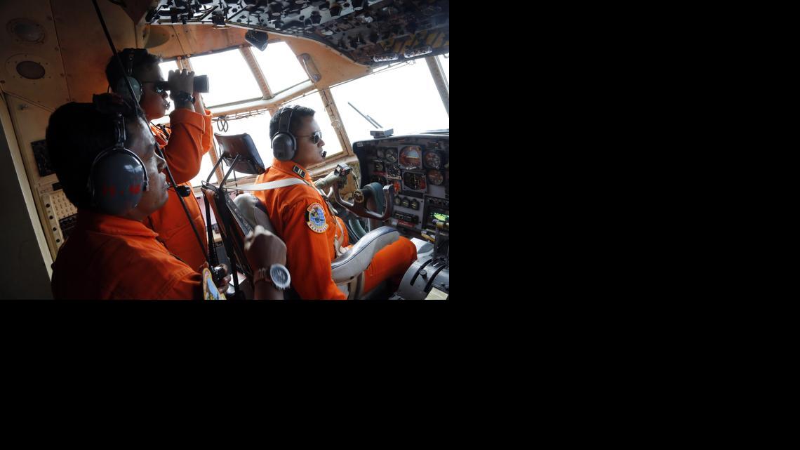 
Crew of Indonesian Air Force C-130 airplane of the 31st Air Squadron scan the horizon during a search operation for the missing AirAsia flight 8501 jetliner over the waters of Karimata Strait in Indonesia, Monday, Dec. 29, 2014. Search planes and ships from several countries on Monday were scouring Indonesian waters over which the AirAsia jet disappeared, more than a day into the region's latest aviation mystery. Flight 8501 vanished Sunday in airspace thick with storm clouds on its way from Surabaya, Indonesia, to Singapore. 
