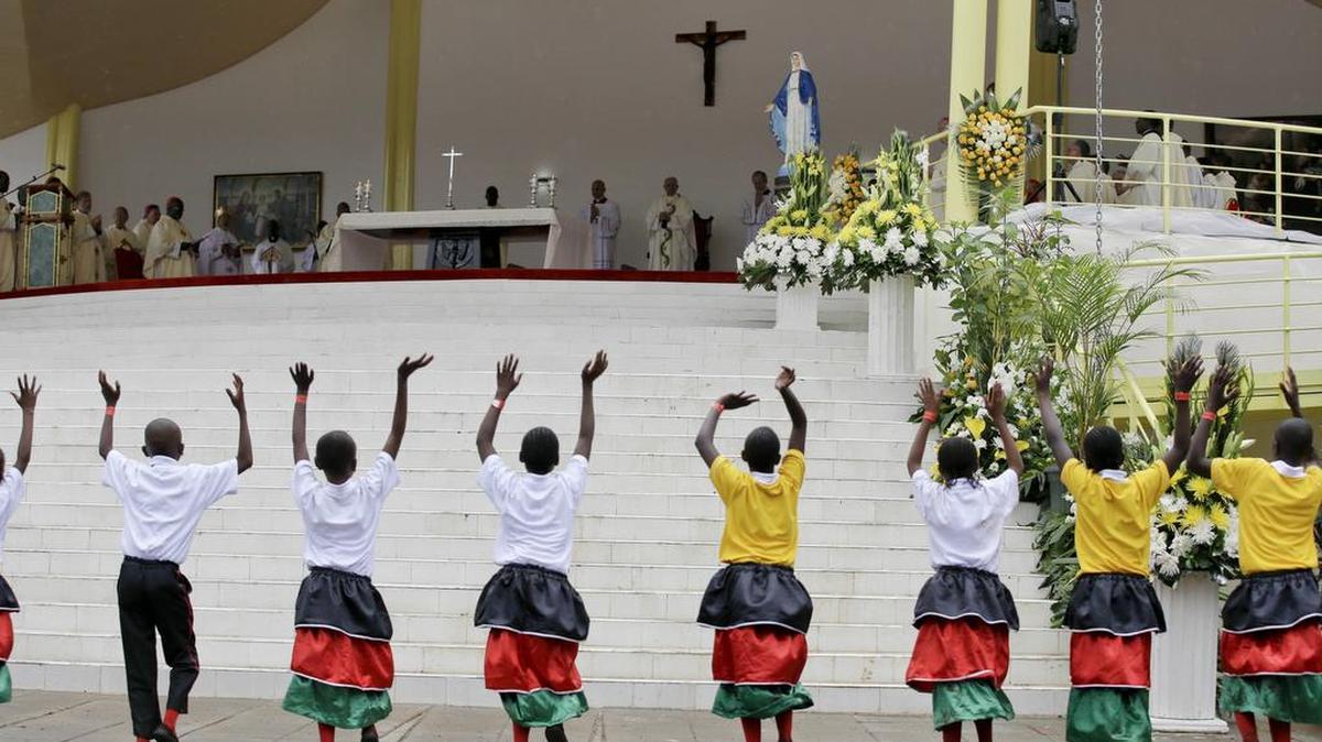Children dance as Pope Francis, beneath the crucifix in the background, celebrates a Mass at the campus of the University of Nairobi, Kenya, Thursday, Nov. 26, 2015. Francis told Christian and Muslim leaders in Kenya on Thursday that they have little choice but to engage in dialogue to guard against the "barbarous" Islamic extremist attacks that have struck Kenya as he kicked off his first full day in Africa with a message of tolerance and peace.