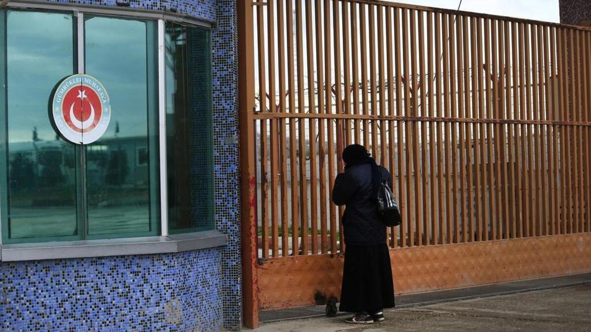 A Syrian woman makes enquiries regarding the possible opening of the closed Turkish border crossing with Syria, on the outskirts of the town of Kilis, in southeastern Turkey, on Sunday, Feb. 7, 2016. Turkey is facing mounting pressure to open its border as tens of thousands of Syrian fleeing a government onslaught and intense Russian airstrikes arrived at the frontier.