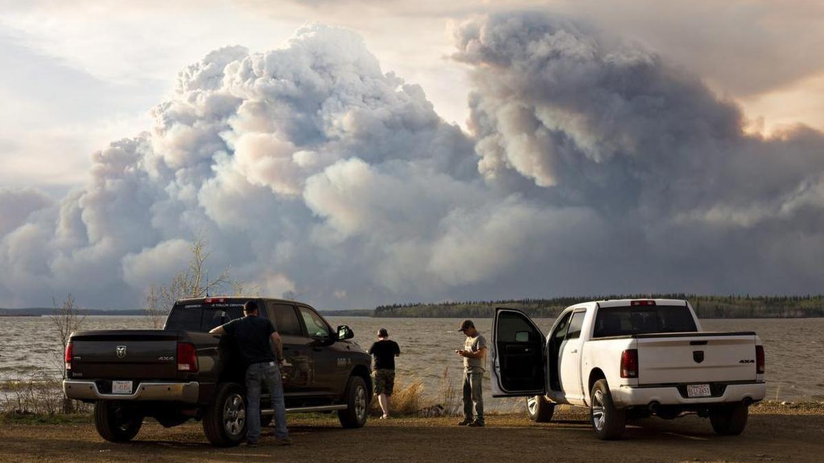 Evacuees watch the wildfire near Fort McMurray, Alberta, on Wednesday. Alberta declared a state of emergency as crews frantically held back wind-whipped wildfires. No injuries or fatalities have been reported.