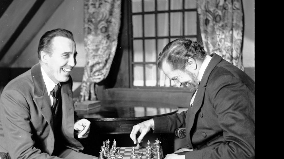
British actor Christopher Lee, left and American actor Vincent Price, share a joke whilst playing chess during a break in the filming of Edgar Allen Poe's "The Oblong Box," at Shepperton Studios, England, on Dec. 17, 1968.
