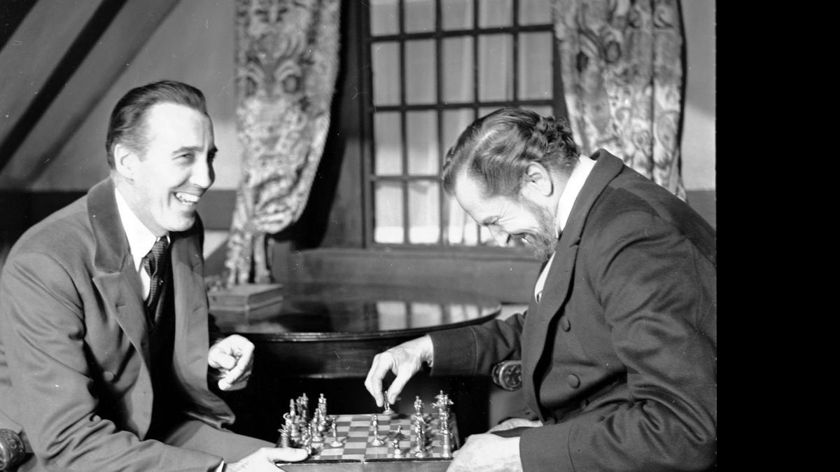 
British actor Christopher Lee, left and American actor Vincent Price, share a joke whilst playing chess during a break in the filming of Edgar Allen Poe's "The Oblong Box," at Shepperton Studios, England, on Dec. 17, 1968.
