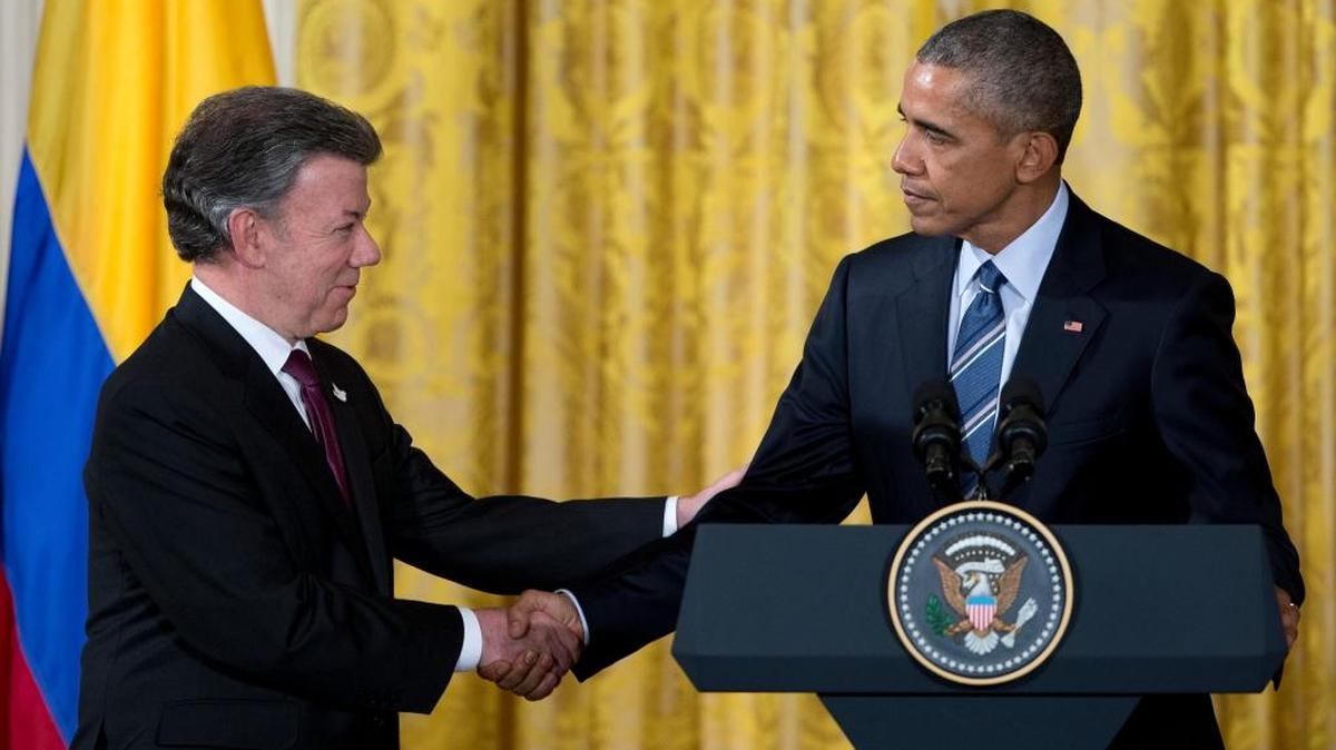 President Barack Obama, right, shakes hands with Colombian President Juan Manuel Santos after speaking at a reception for Plan Colombia, the joint effort to create a safer, more prosperous future for Colombians, in the East Room of the White House in Washington on Thursday, Feb. 4, 2016.