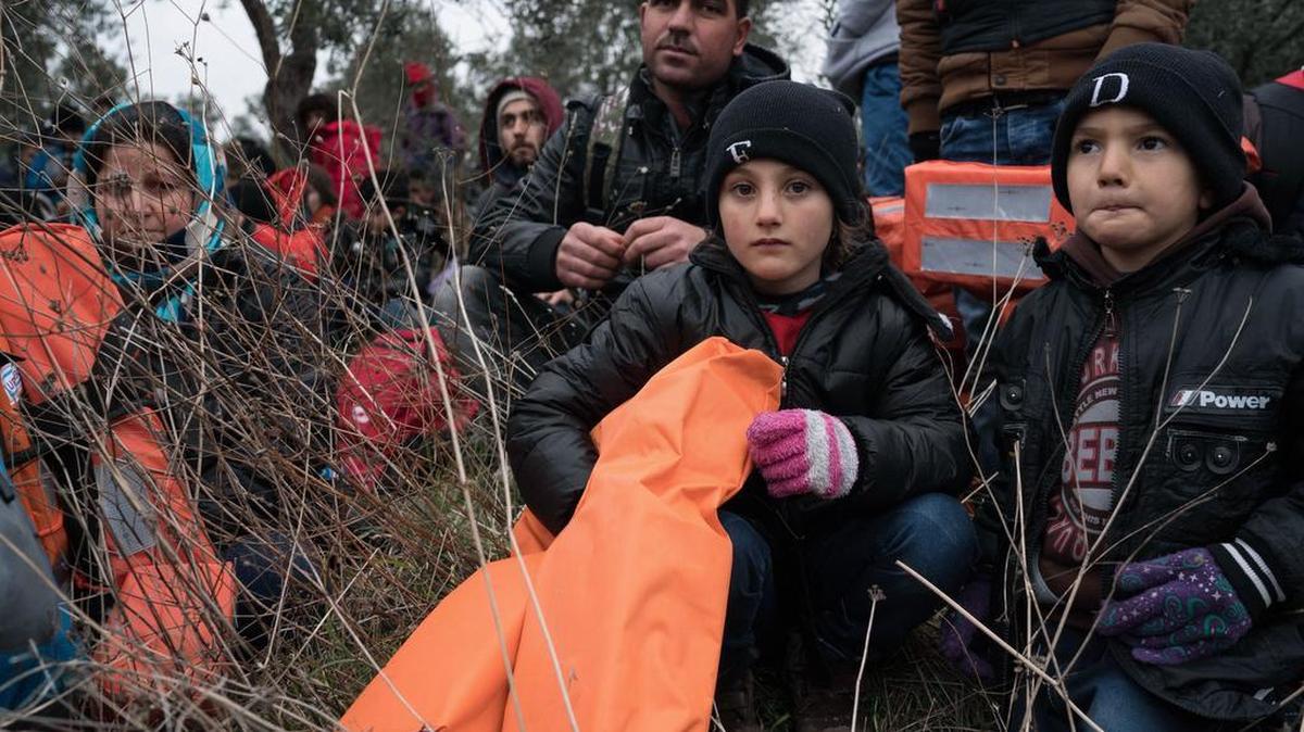 Migrants wait to travel to the Greek island of Lesbos, near the Aegean town of Ayvacik, Turkey, on Friday, Jan. 29, 2016. Italian Premier Matteo Renzi said in Berlin on Friday that he is expecting an answer soon from the European Commission on his country’s questions about providing 3 billion euros in aid to Turkey to help with Syrian refugees.