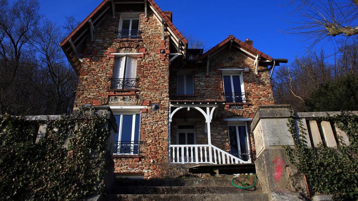 The Airbnb rental property where a decomposing body of a woman was found in the garden, in Palaiseau, south of Paris, France, Monday, Feb. 29, 2016. Bertrand Daillie, the deputy prosecutor for Evry, said a group of young people who were renting the house for a weekend discovered the badly decomposed body in the garden near the edge of the property. He says it was covered by tree branches that had been placed there deliberately.