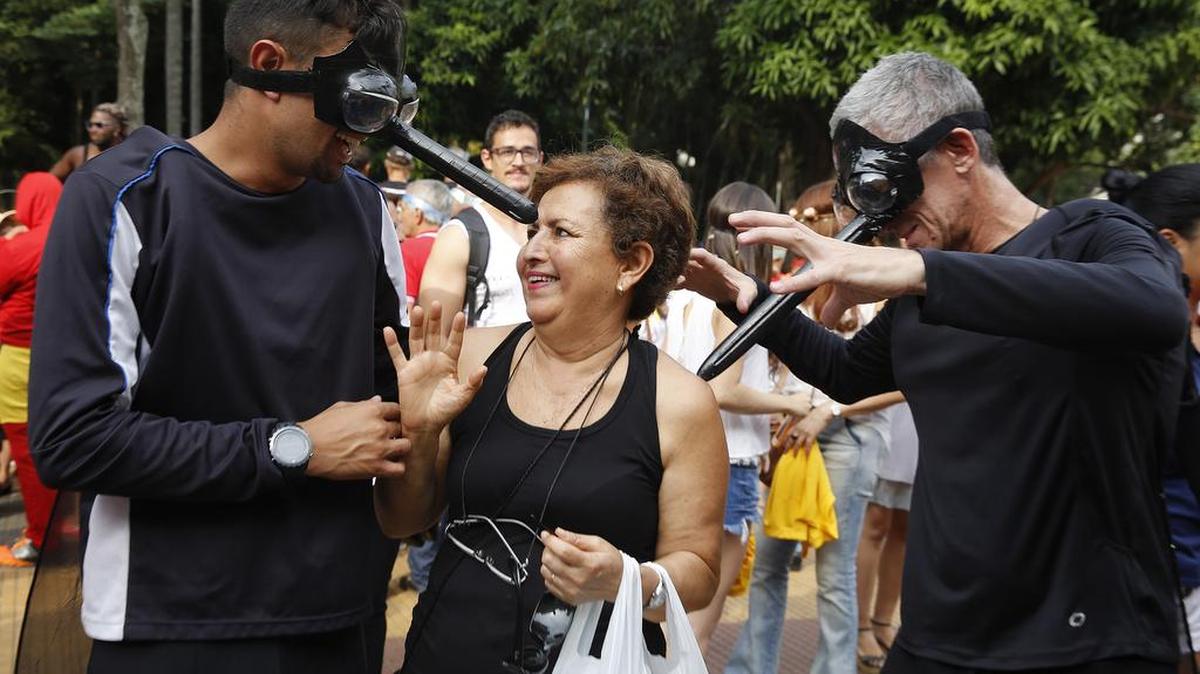 Public health workers wear Aedes aegypti mosquito costumes playfully descend on a reveler during a street carnival block party as part of a campaign to warn people about the spread of the Zika virus, in Sao Paulo, Brazil, Thursday. With no hope for a vaccine to prevent Zika in the near future, authorities are focusing on the most effective way to combat the virus: killing the mosquito that carries it.