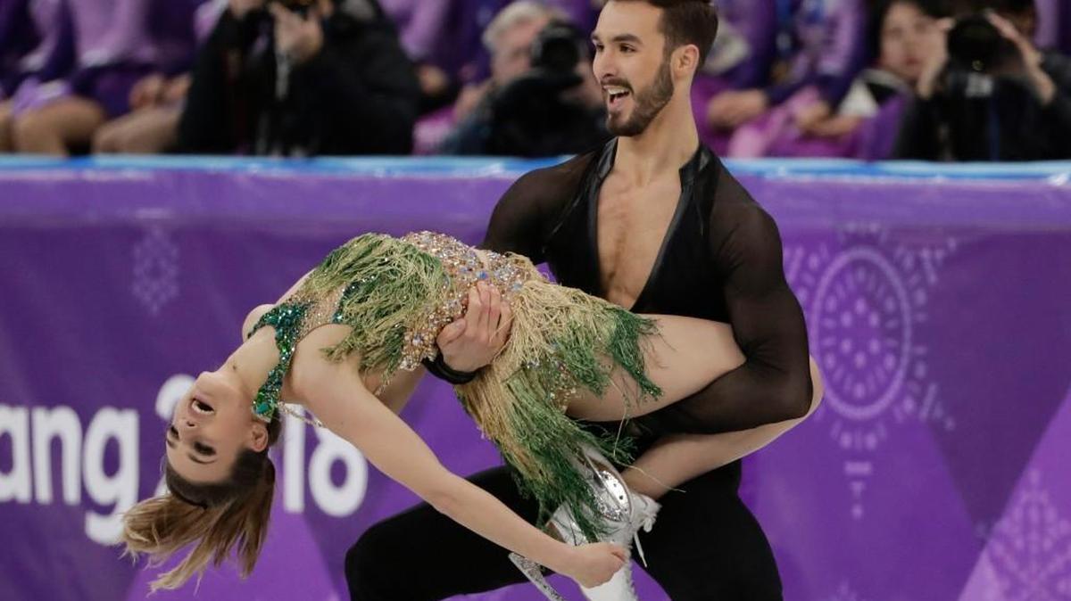 Gabriella Papadakis and Guillaume Cizeron of France kept skating, even though her halter dress came loose.