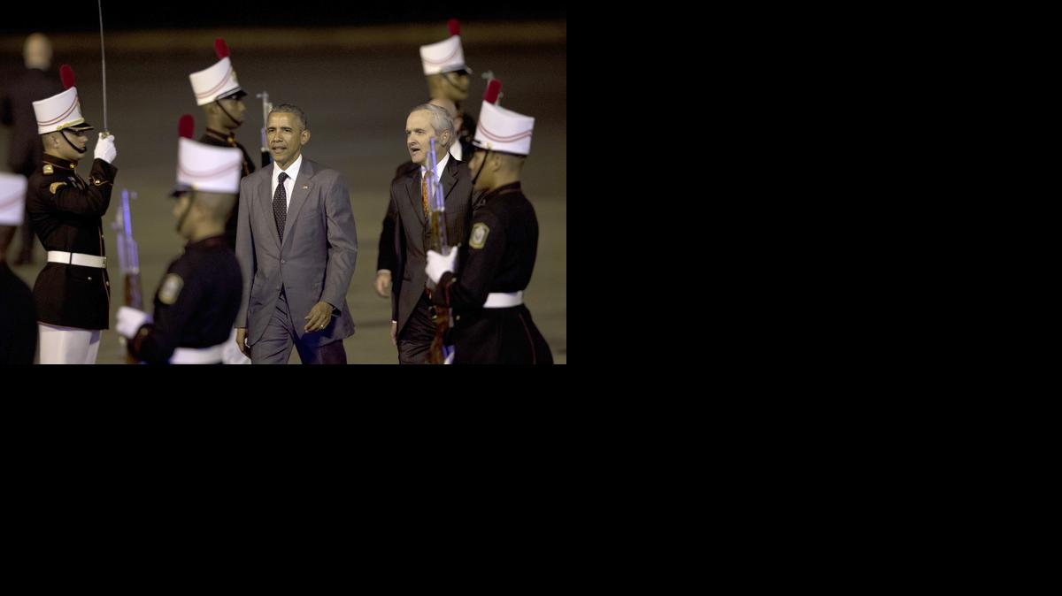 
President Barack Obama walks past the honor guard with Alvaro Aleman, Panama's Minister of Foreign Affairs, upon his arrival at the Tocumen international airport in Panama City, Panama, April 9, 2015, for the VII Summit of the Americas. 
