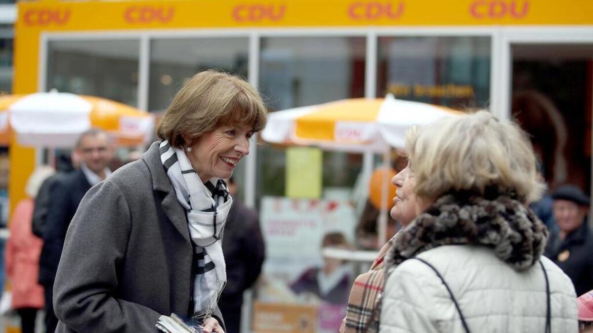 
Independent candidate for the mayor of Cologne Henriette Reker talks to residents on Friday, Oct. 16, 2015, during her election campaign in Cologne, Germany. Reker was wounded in a stabbing as she campaigned on Saturday, Oct. 17, 2015, a day before an election in the western German city. 
