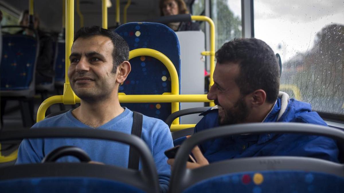 Osman al-Haj Osman, left, rides on a bus on Wednesday, Sept. 16, 2015, in Saarlouis, Germany, with his friend Mohammed al-Haj, who recently arrived from Aleppo, Syria.