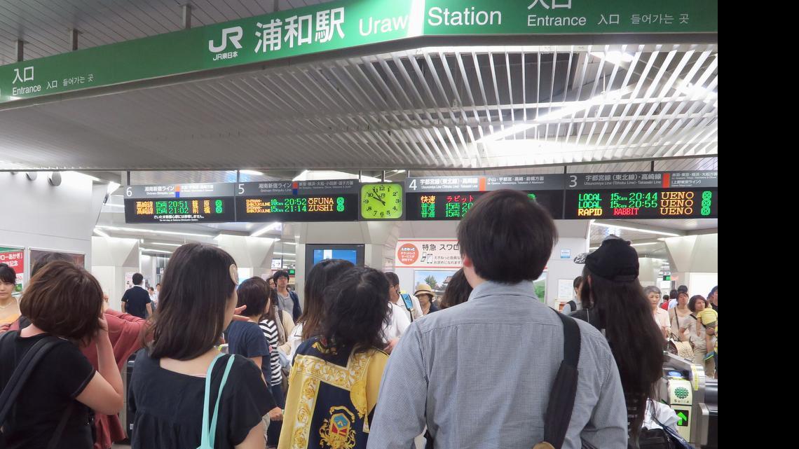 
Passengers check the timetable after a strong earthquake stopped and delayed some train services in Tokyo metropolitan area, at JR Urawa Station in Urawa, north of Tokyo Saturday, May 30, 2015. 
