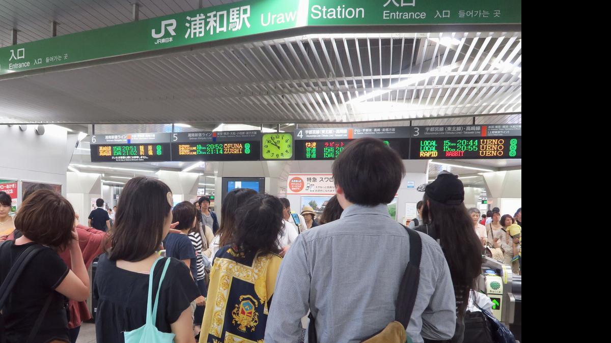 
Passengers check the timetable after a strong earthquake stopped and delayed some train services in Tokyo metropolitan area, at JR Urawa Station in Urawa, north of Tokyo Saturday, May 30, 2015. 
