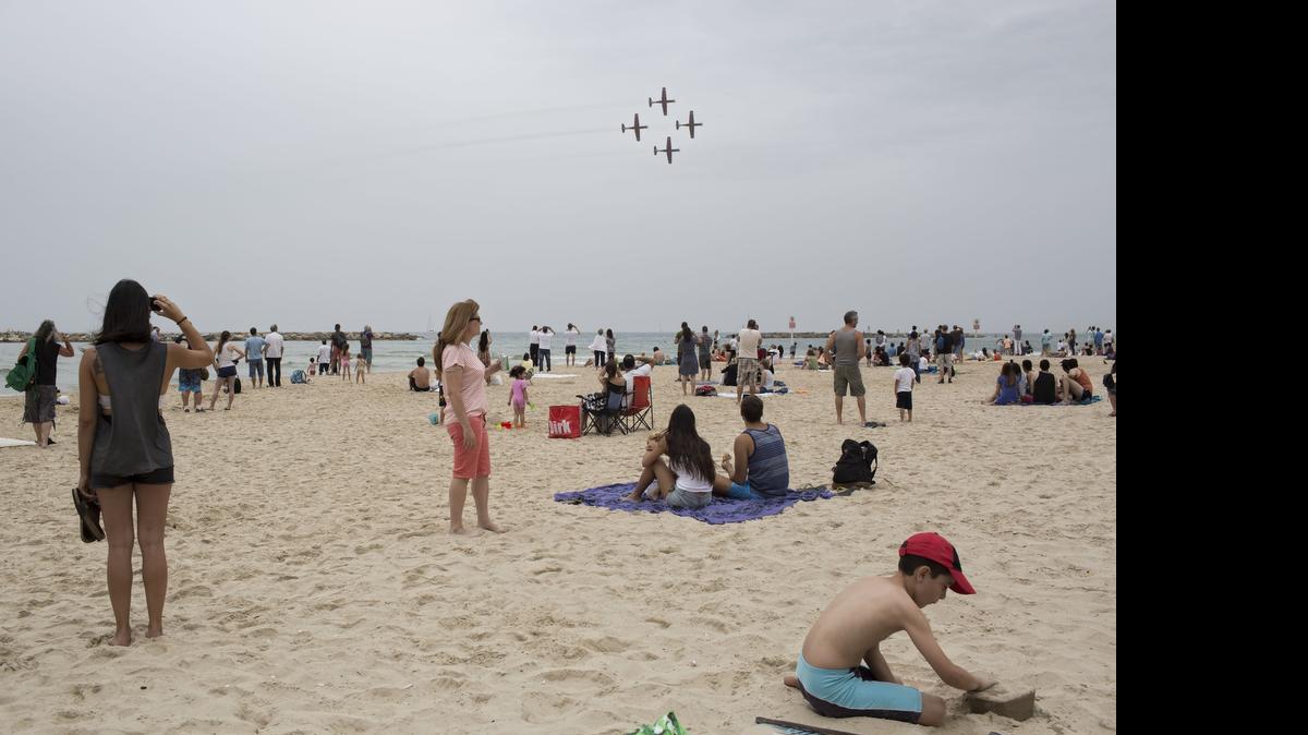 
In this Tuesday, May 6, 2014 file photo, Israelis watch an air show during Independence Day in Tel Aviv. The world’s Jewish population has grown to be nearly as large as it was before the Holocaust, an Israeli think tank said in its annual report Sunday, June 28, 2015. 
