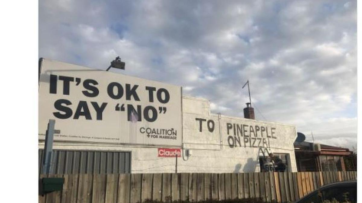 It’s OK to say no ... to pineapple on pizza, the building now reads.